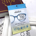 Aarenzza reusable anti-fog cloth for glasses, showing a person cleaning clear lenses with the soft cloth in a kitchen setting.