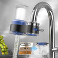 Arenzza faucet water purifier with adapters, installed on a kitchen sink, demonstrating its sleek design and water flow.