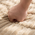 Arenzza quilted corduroy non-slip sofa cushion in neutral color, designed for comfort and stability on a living room sofa.