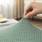 Arenzza Jacquard knitted stretch sofa cover in a cozy, textured design protecting a sofa in a home setting.