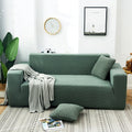 Arenzza Jacquard knitted stretch sofa cover in a stylish design, fitting snugly over a sofa for a fresh, cozy look.