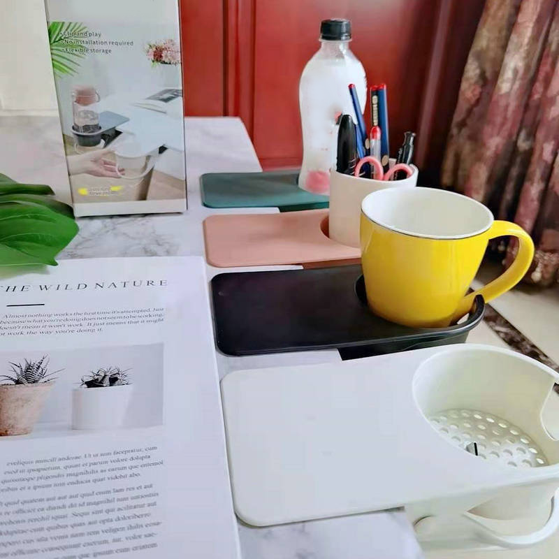 Arenzza clip-on desk cup holder attached to a desk edge, holding a coffee mug in a home office or kitchen setting.