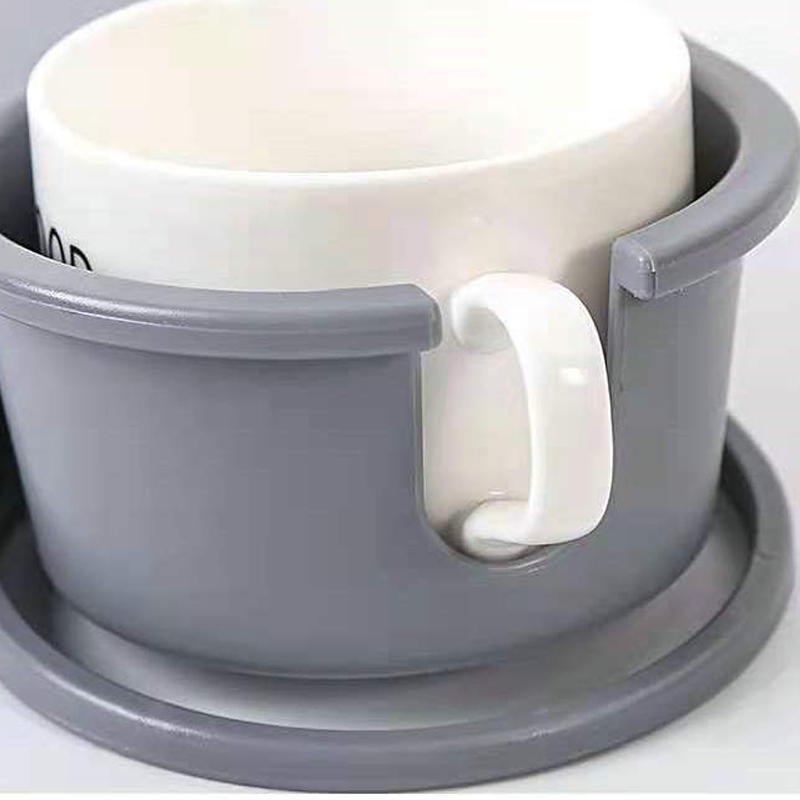 Arenzza clip-on desk cup holder attached to a desk, holding a coffee mug in a kitchen or office setting.