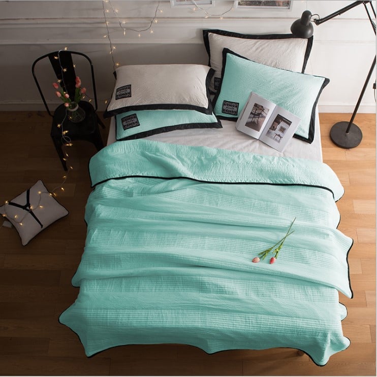 Arenzza ice cooling calming blanket on a bed, designed for summer sleep comfort with a soft, breathable fabric for peaceful rest.