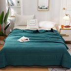 Arenzza ice cooling calming blanket spread over a bed, designed for peaceful summer sleep with cooling, soft fabric.