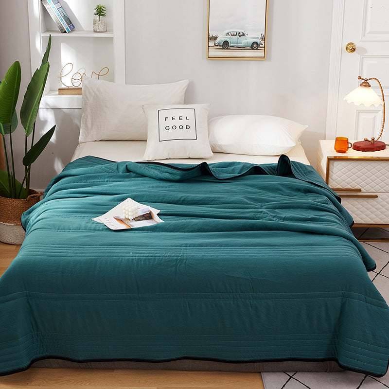 Arenzza ice cooling calming blanket spread over a bed, designed for peaceful summer sleep with cooling, soft fabric.