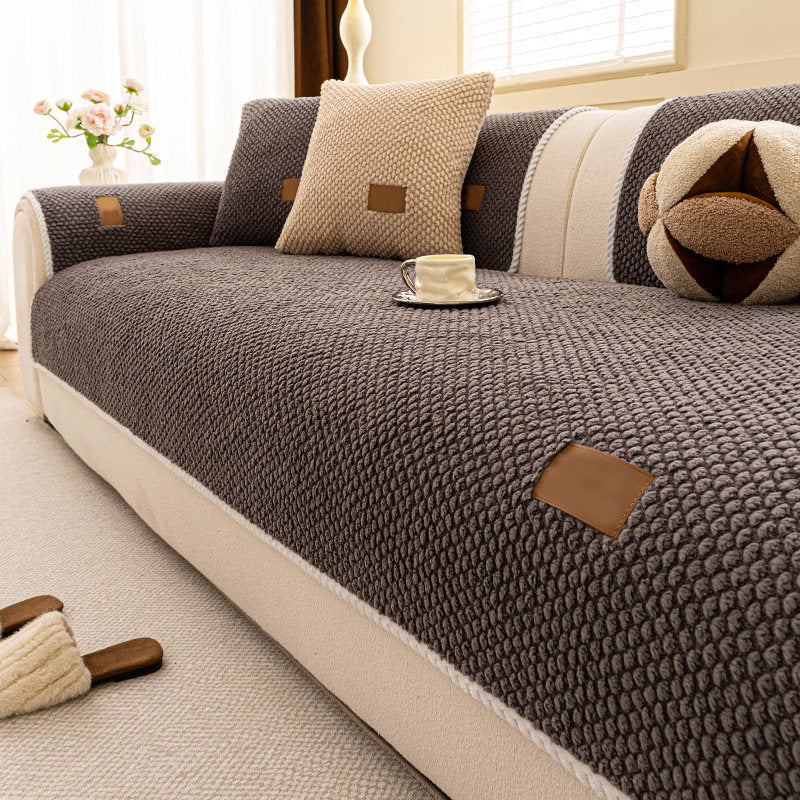 Arenzza thickened non-slip washable sofa cover draped over a sofa, showcasing its textured fabric and secure fit for houseware and kitchen use.