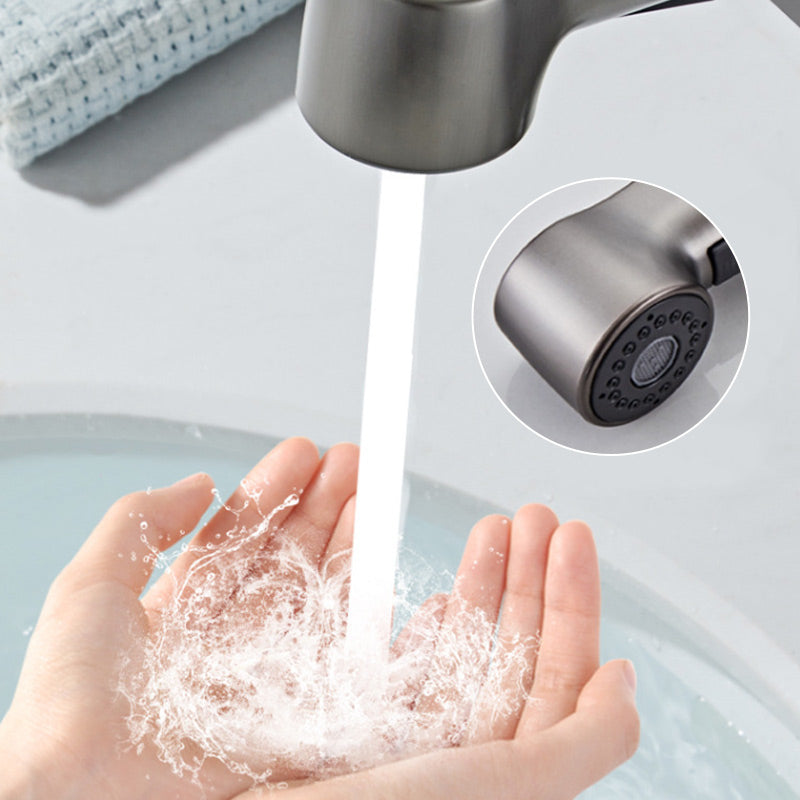 Arenzza single-hole bathroom faucet with pull-out sprayer, chrome finish, installed on a modern bathroom sink with water flowing.