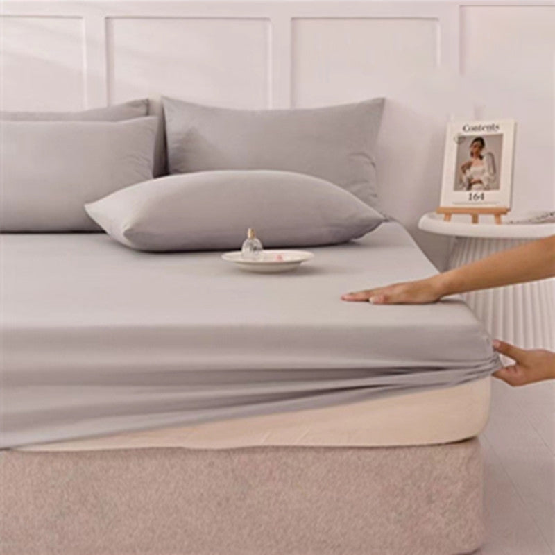 A set of three soft, easy-fit sheets from Arenzza in various colors, displayed on a neatly made bed for a houseware and kitchen product.
