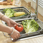 Arenzza stainless steel telescopic drainer basket for kitchen, with adjustable extendable design and mesh drainage surface.