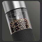 Arenzza electric pepper and salt grinder set in black and silver, with stainless steel grinding mechanisms on a kitchen countertop.