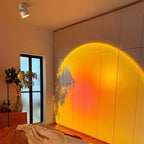 Arenzza LED Sunset Projection Lamp casting warm sunset light in a cozy home setting for photography and decoration.