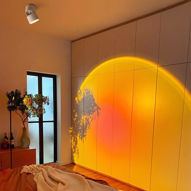 Arenzza LED Sunset Projection Lamp casting warm sunset light in a cozy home setting for photography and decoration.