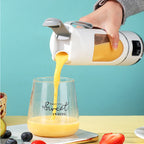 Arenzza portable cordless juicer in white with a transparent juice container and stainless steel accents, ready for use.