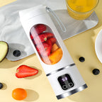 Arenzza portable cordless juicer in white with a transparent juice container, showing its compact design for kitchen and houseware use.