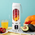 Arenzza portable cordless juicer in white with a transparent juice container and black lid, designed for quick fruit and vegetable juicing.