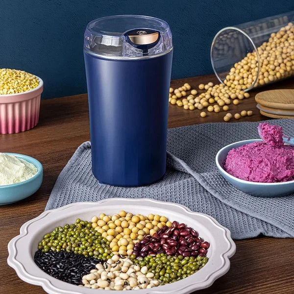 Arenzza portable grinder for beans and spices, compact kitchen appliance with stainless steel grinding chamber and black plastic body.