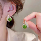 A pair of Arenzza elegant simulated pearl and rhinestone stud earrings with sparkling accents, perfect for jewelry accessories.