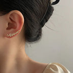 A pair of elegant leaf-shaped stud earrings by Arenzza, showcasing detailed jewelry accessories with a refined design.