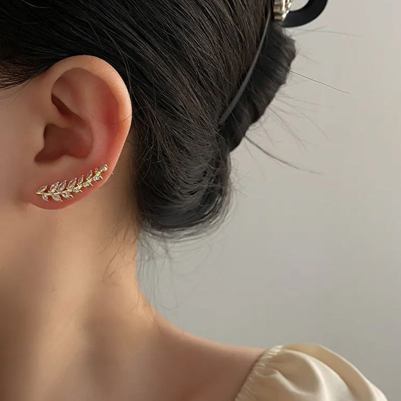 A pair of elegant leaf-shaped stud earrings by Arenzza, showcasing detailed jewelry accessories with a refined design.