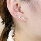 Elegant leaf-shaped stud earrings from Arenzza, showcasing detailed jewelry accessories with a sleek, polished leaf design.
