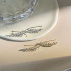 A pair of elegant leaf-shaped stud earrings from Arenzza jewelry accessories, featuring intricate leaf design and shiny finish.