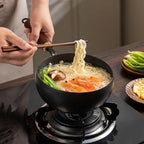 Aarenza uncoated thick iron kitchen pot with lid, showing a sturdy black cast iron cooking vessel on a kitchen surface.