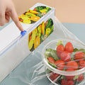 Arenzza easy-cut stretch clear food wrap in a roll, used for covering and sealing food containers in the kitchen.