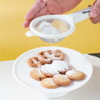 Arenzza 7-piece kitchen gadget set with spatulas, tongs, and utensils arranged on a countertop in a modern kitchen setting.