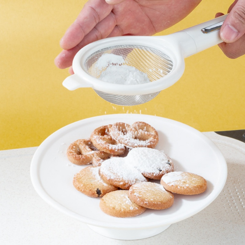 Arenzza 7-piece kitchen gadget set with spatulas, tongs, and utensils arranged on a countertop in a modern kitchen setting.