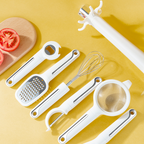 Arenzza 7-piece kitchen gadget set including spatulas, tongs, and spoons arranged on a countertop.