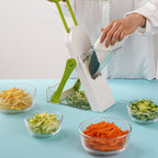 Arenzza multifunctional vegetable chopper in a kitchen setting with chopped vegetables and blades ready for use.