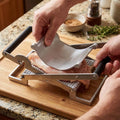 Arenzza K-MONT Schnitzelmaschine Fleischpresse in kitchen, stainless steel meat press with handle for pounding and flattening meat.