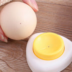 Arenzza egg piercer with safety lock, shown in use on a kitchen countertop, designed for easy and safe egg piercing.