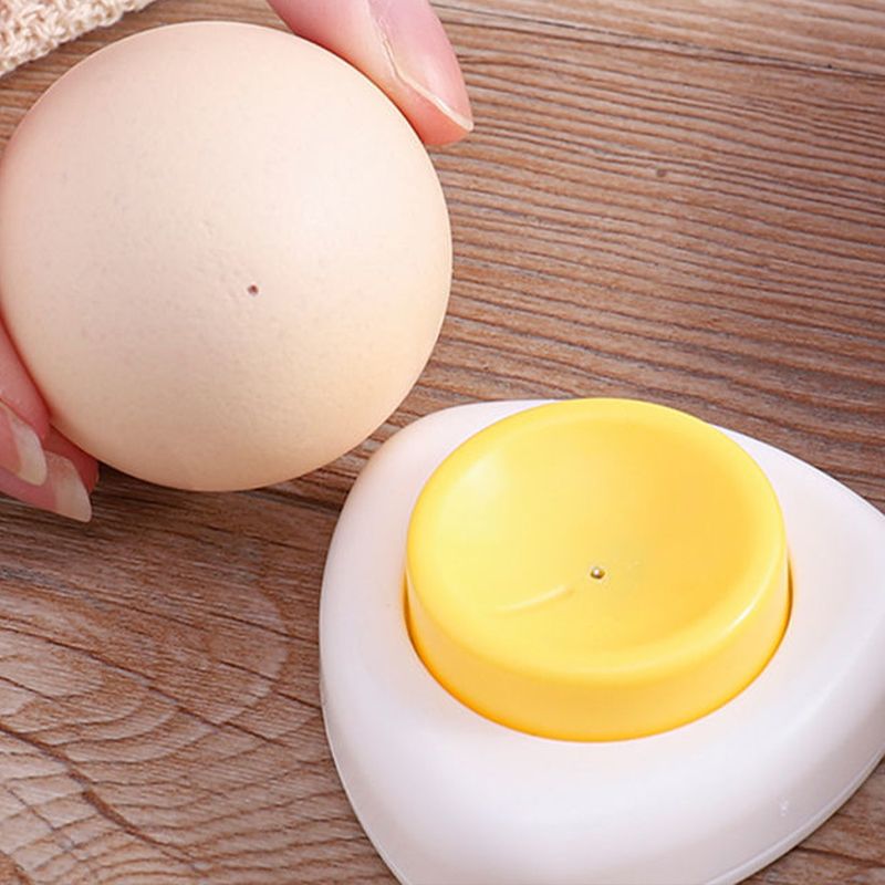 Arenzza egg piercer with safety lock, shown in use on a kitchen countertop, designed for easy and safe egg piercing.