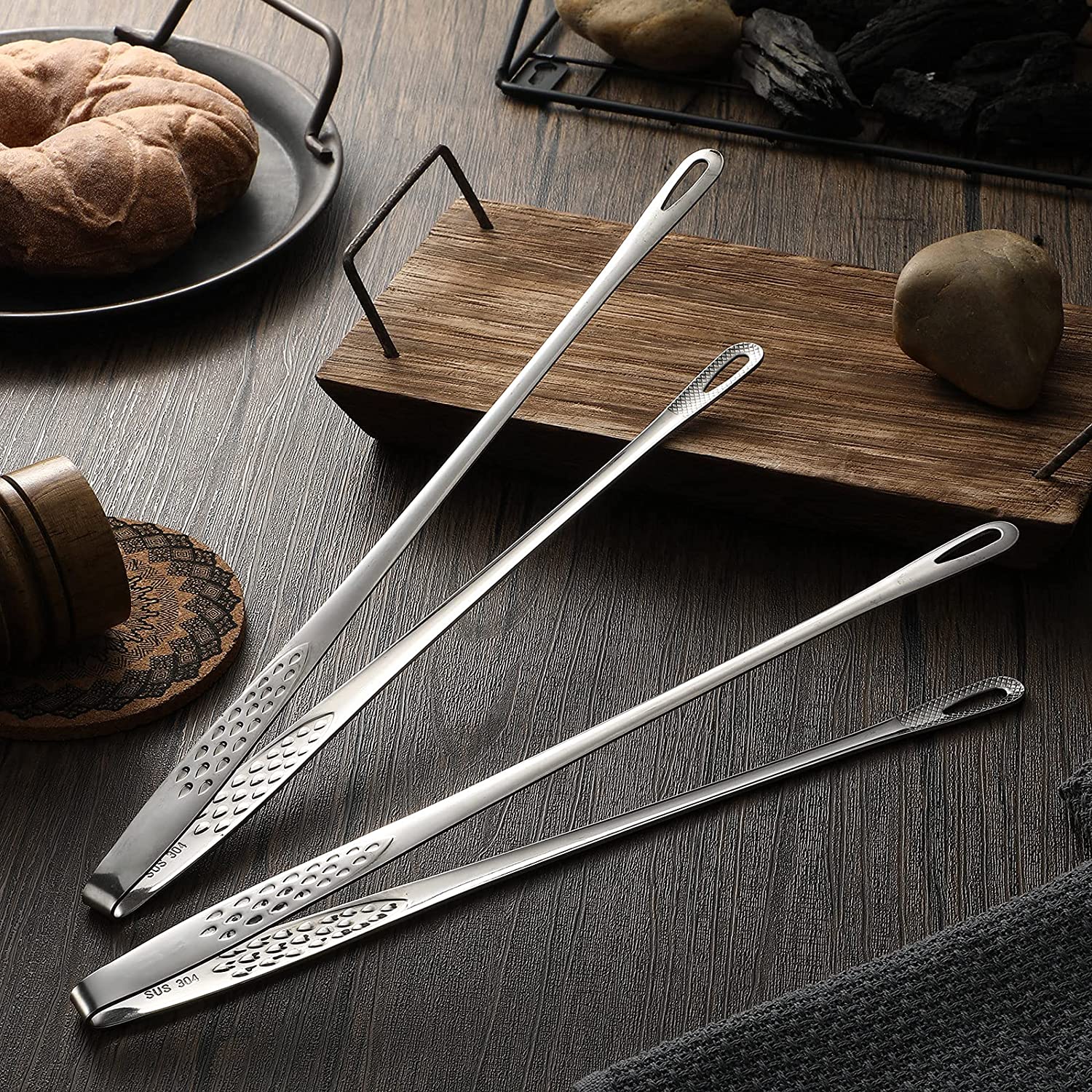 Arenzza stainless steel barbecue tongs with a durable grip, ideal for grilling and outdoor cooking in a kitchen setting.