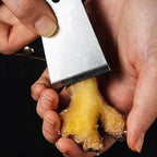 Arenzza Sharp & Portable Ginger Peeler in kitchen setting, showcasing its compact design and stainless steel blade for peeling ginger efficiently.
