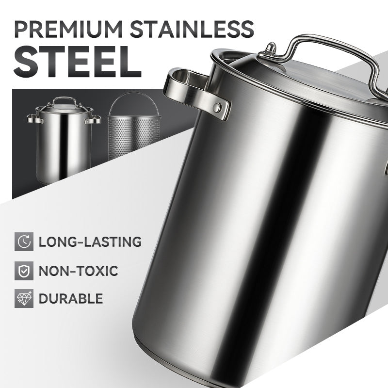 Aarenza stainless steel asparagus and pasta pan with handles, filled with cooked pasta and fresh asparagus, on a kitchen countertop.