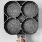 Arenzza four-hole non-stick egg pan with handle, ideal for breakfast omelettes and home frying, shown on a kitchen countertop.