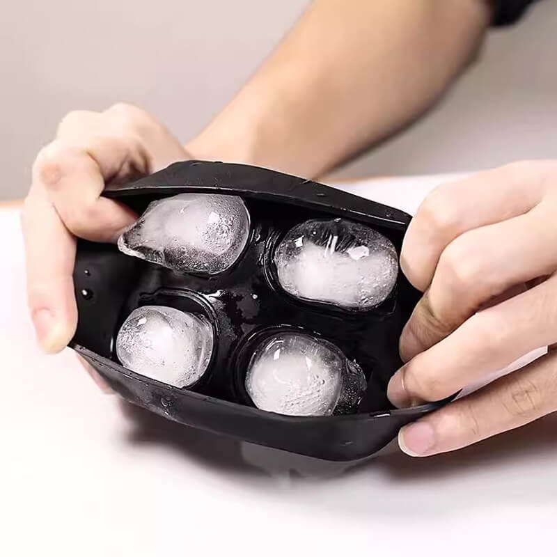 Aarenza silicone skull ice cube tray with large, detailed skull molds for whiskey and cocktails in a kitchen setting.