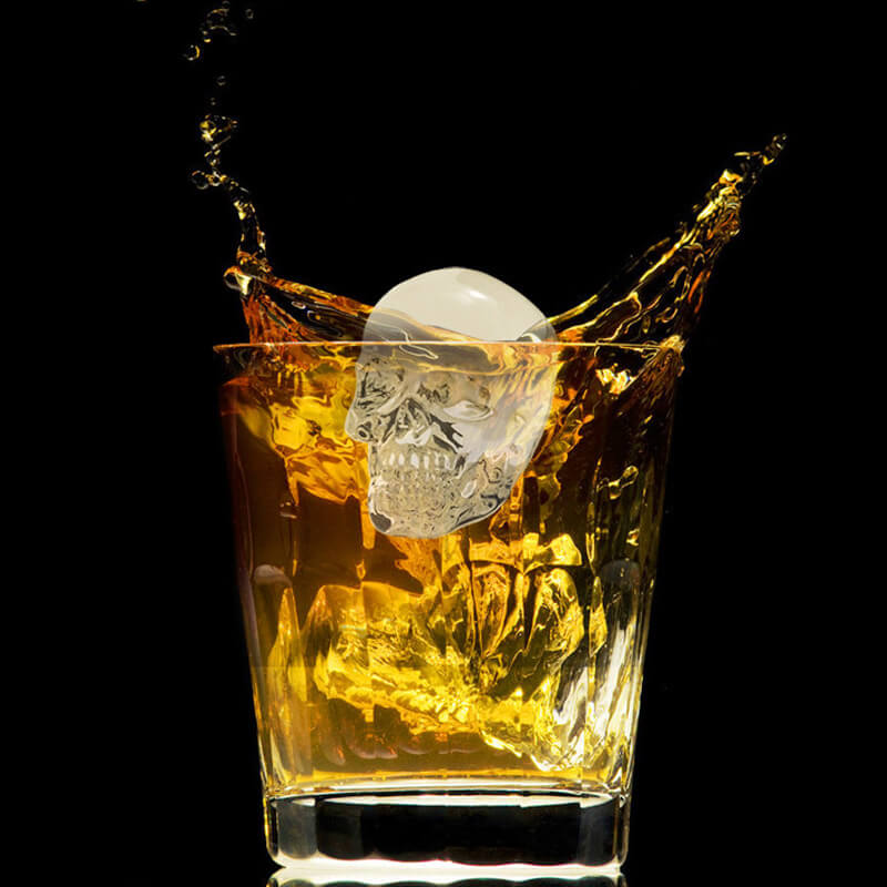 Arenzza silicone skull ice cube tray with giant slow-melt skull molds for whiskey and cocktails in a kitchen setting.