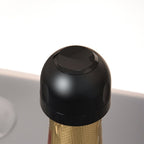 Arenzza wine, beer, and champagne stoppers with silicone seals for airtight sealing, shown in a kitchen setting.