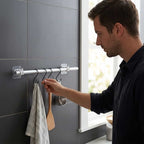A set of Arenzza SmartGrip™ damage-free wall hooks holding keys and accessories on a modern wall in a home or office setting.