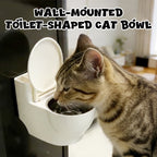A wall-mounted, toilet-shaped cat bowl in white with a removable tray, designed for pet supplies by Arenzza.