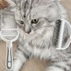 Arenzza dual-sided pet grooming rake for pet supplies, features ergonomic handle and stainless steel blades for fur detangling.