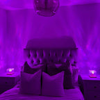 Aarenzza Northern Lights bedroom lamp emitting colorful, minimalist room decor lighting on a modern bedside table.