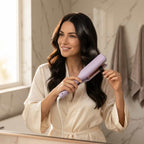 A woman with smooth, French-style curls using the Arenzza SmoothCurl™ curling iron in a modern lifestyle setting.