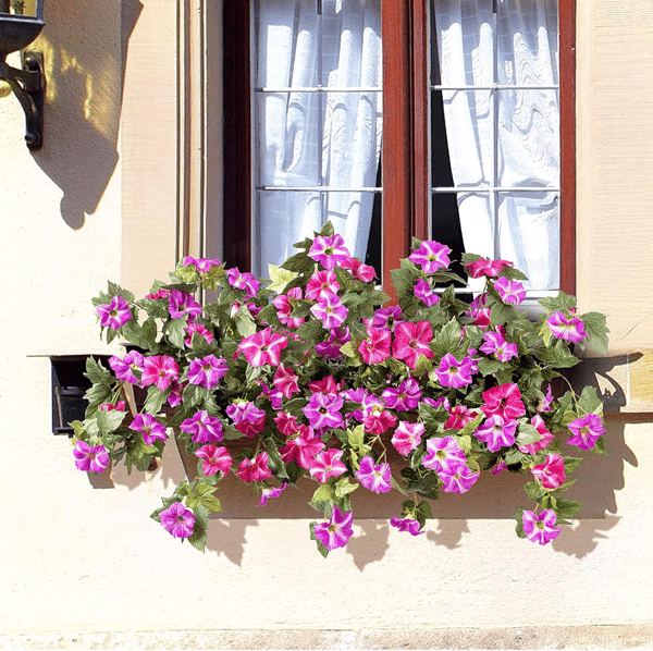 Artificial Petunias by Arenzza, weatherproof floral display with vibrant, lifelike purple and pink petunia flowers in a garden setting.