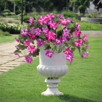 Lifelike Arenzza artificial petunias in a weatherproof floral display with vibrant purple and green leaves.