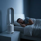 A person relaxing in a living room with an Arenzza AirCool™ air purifier, emphasizing clean, dust-free indoor air.